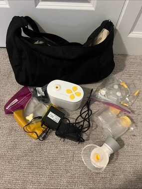 Medela White Breast Pump with Yellow Control Buttons and Black Bag